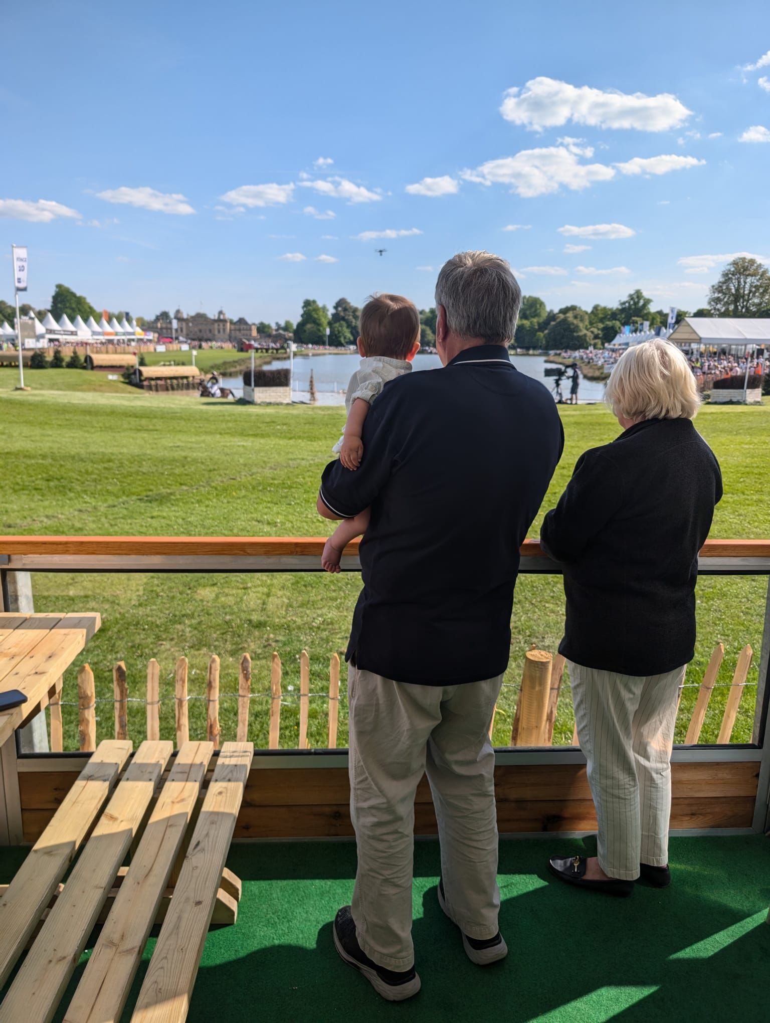 Adrian and Mary Dann watching the horses with their grandchild
