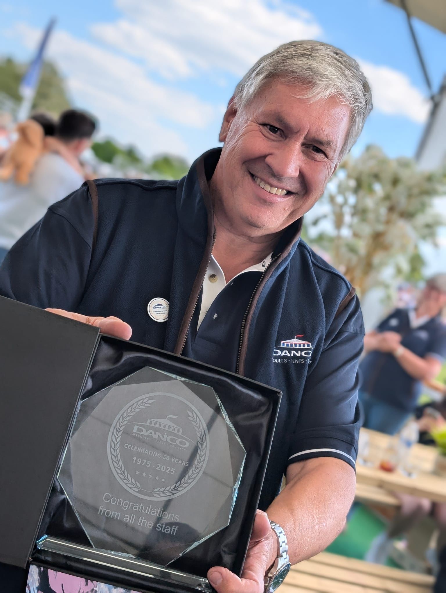 Managing Director of Danco Marquees celebrating 50 years in the industry with an ornamental gift from the staff. 