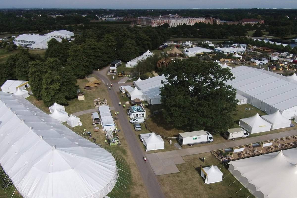 Aerial view at RHS Hampton Court Flower Show showing traditional marquee with round end, hats and clearspan marquees