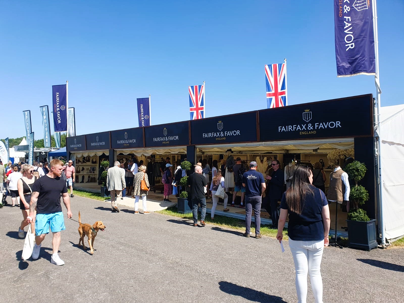 Fairfax & Favour trade stand at Devon County Show. The company branding is displayed across the marquee structure which is filled with their products. 