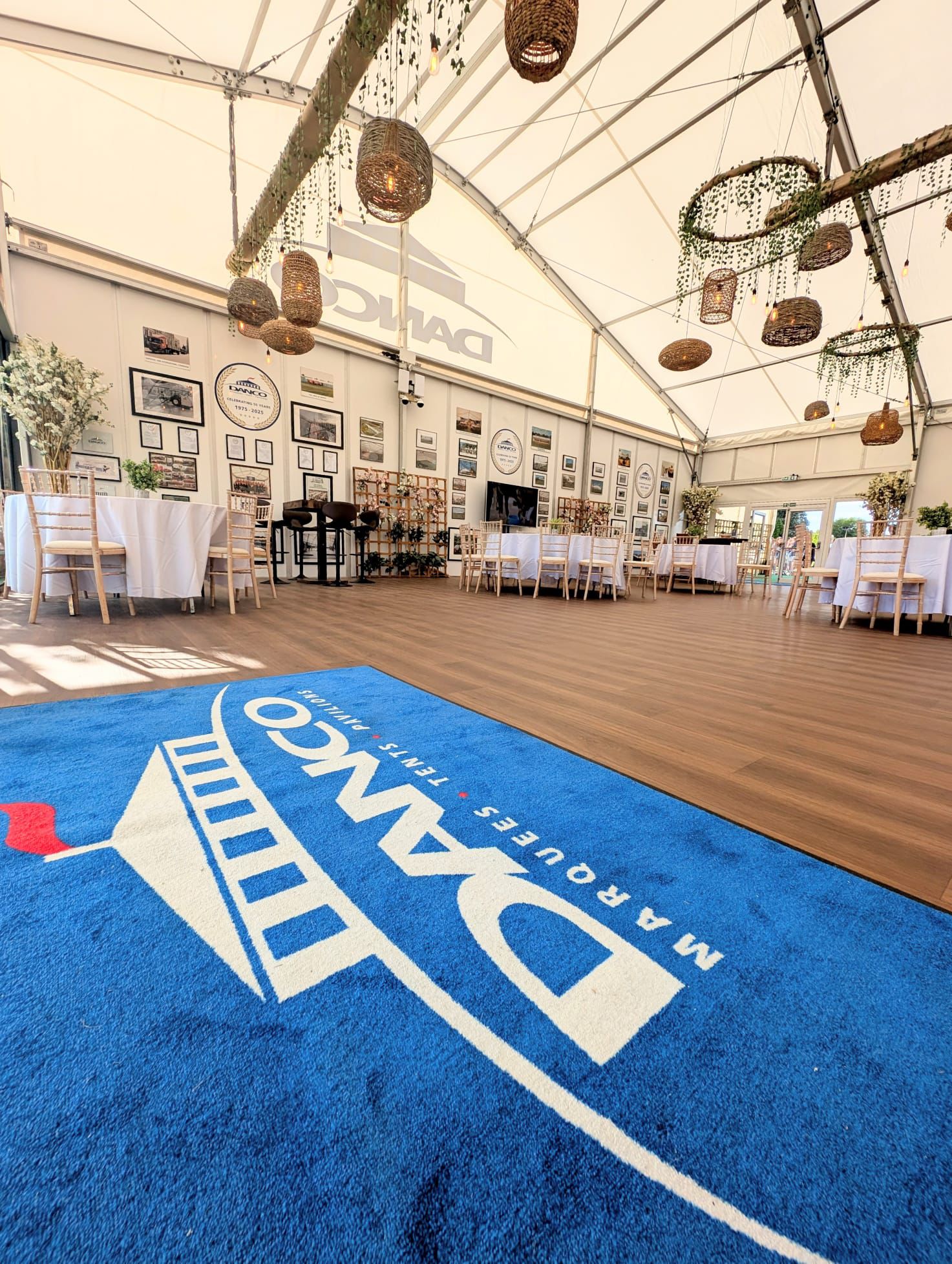 A large blue matt, with a Danco Marquee logo in white inside the Danco hospitality marquee. 