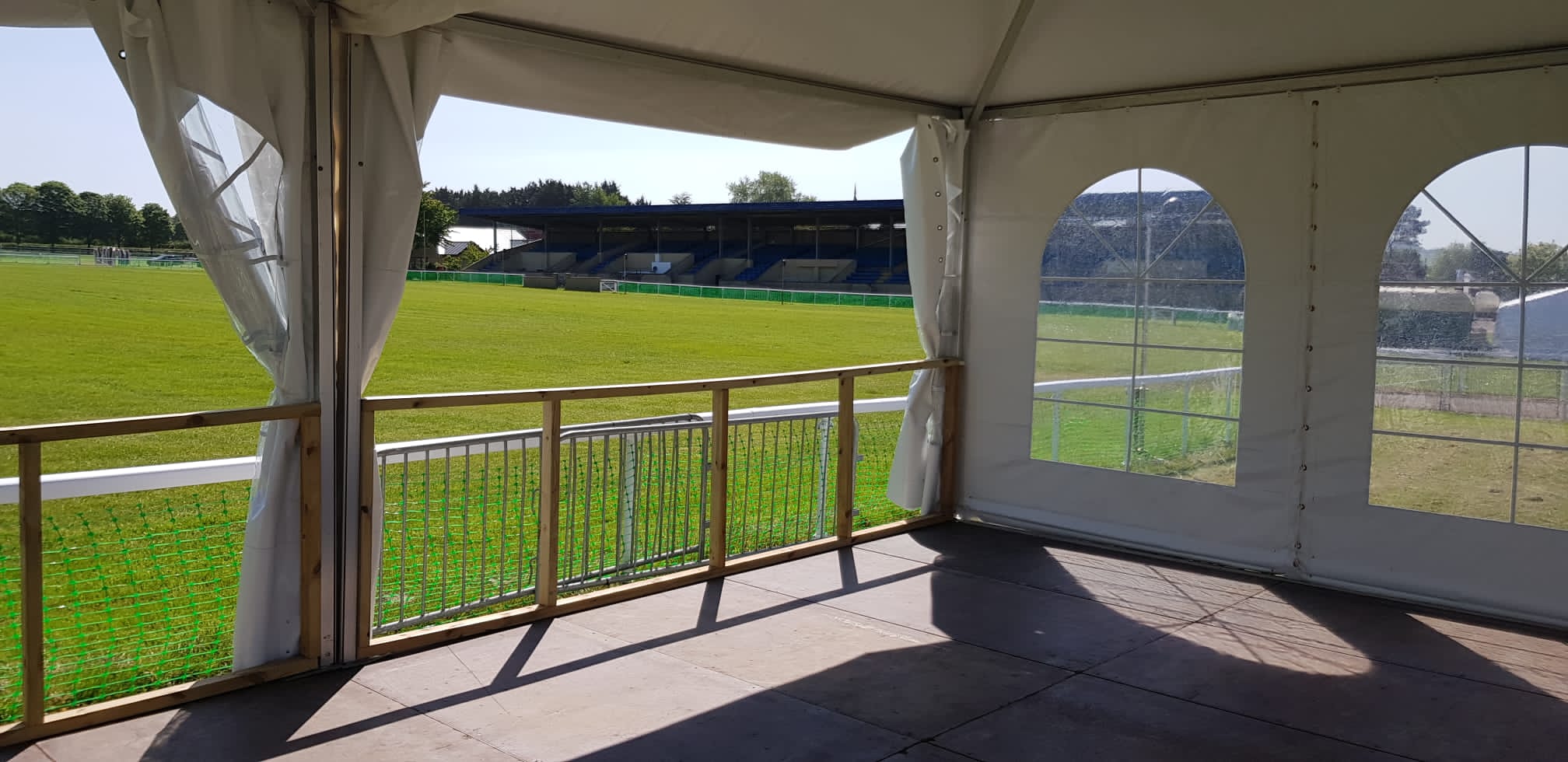 Danco marquee with open walls and window walls looking out onto an arena. 