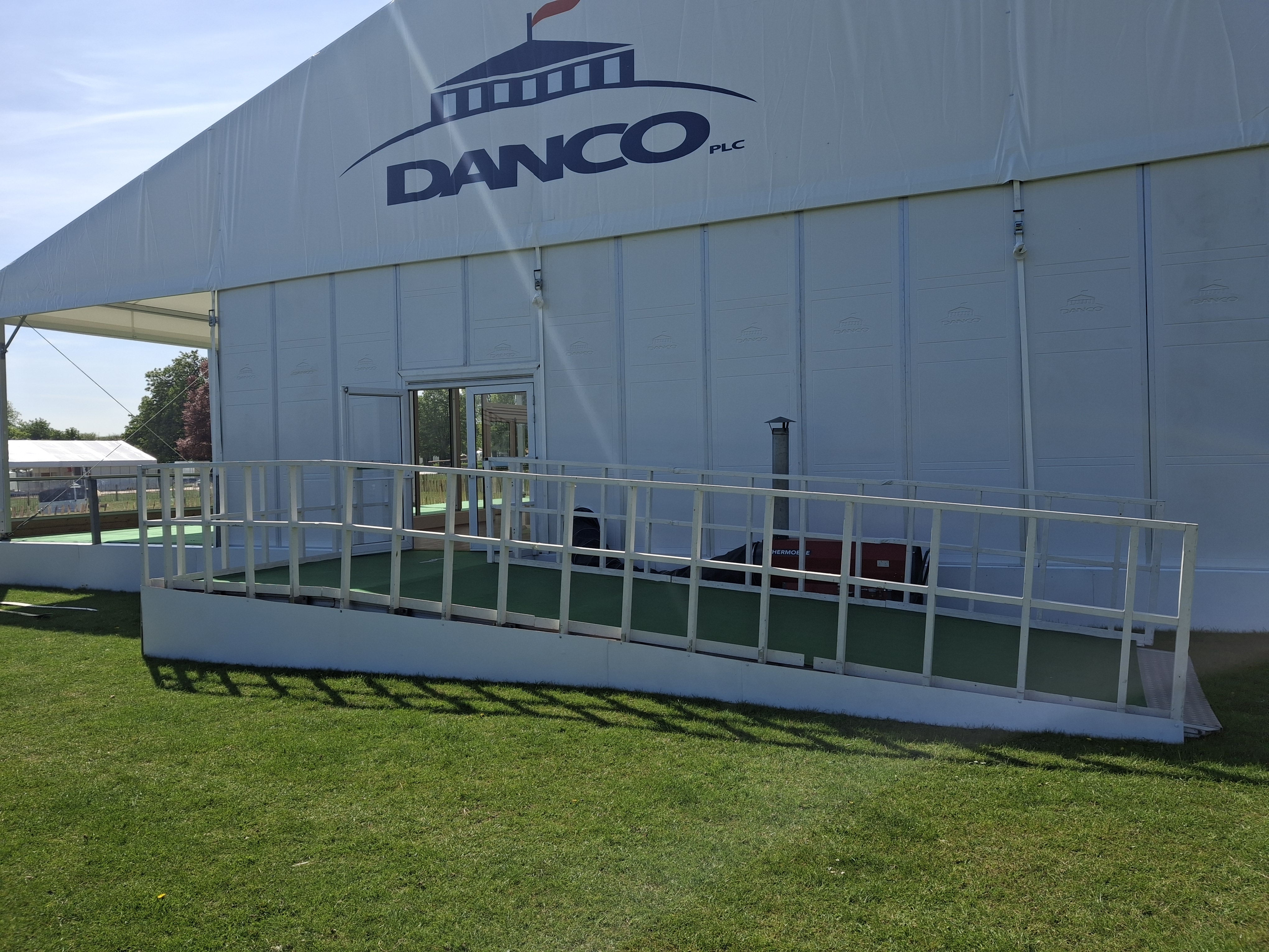 Solid sided marquee with viewing platform and large ramp